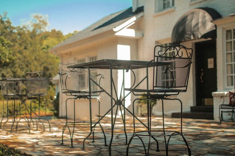 two chairs and a table on a brick patio