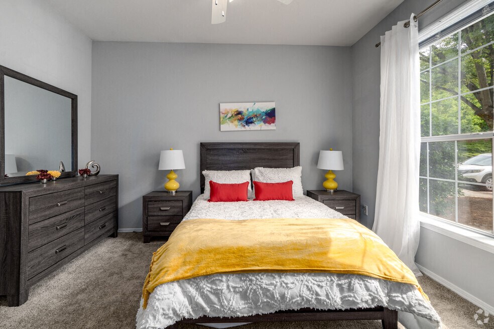 a bedroom with a bed and a large window