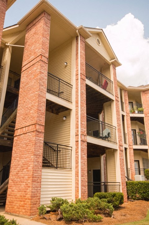 an apartment building with brick columns and balconies