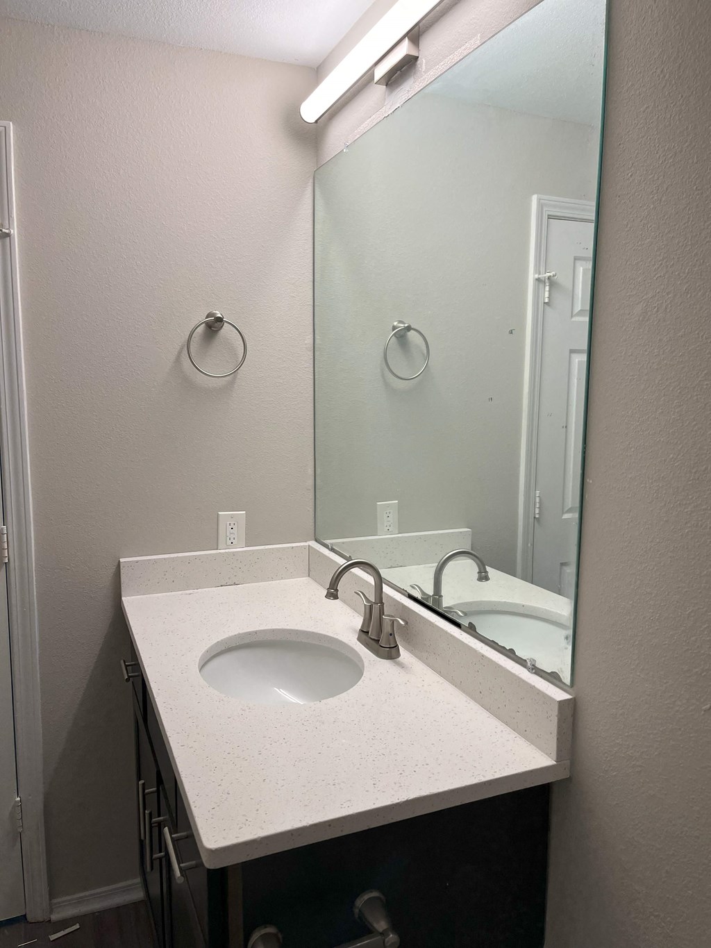 a bathroom with a sink and a large mirror