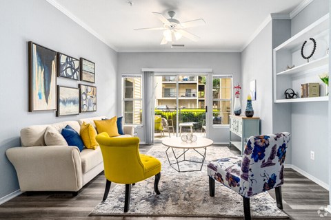 a living room with blue walls and yellow and gray furniture