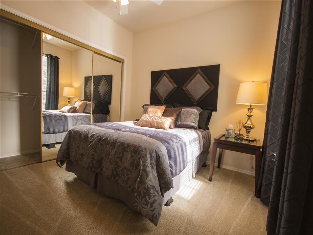 a bedroom with a bed and a mirror