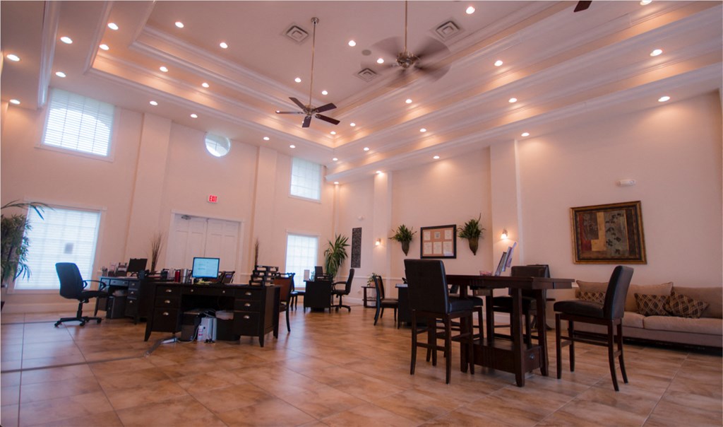 a large conference room with tables and chairs and a ceiling fan