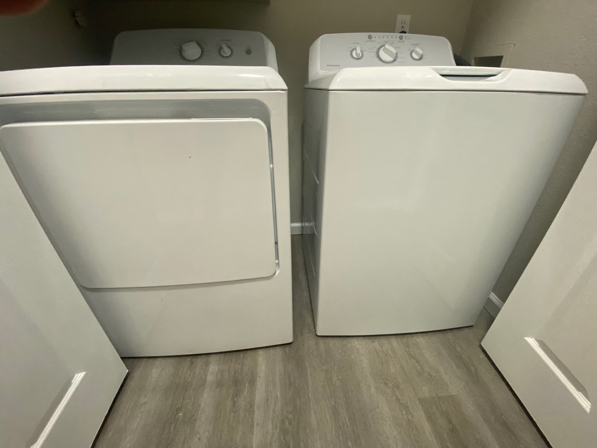 two white washers and dryers in a room