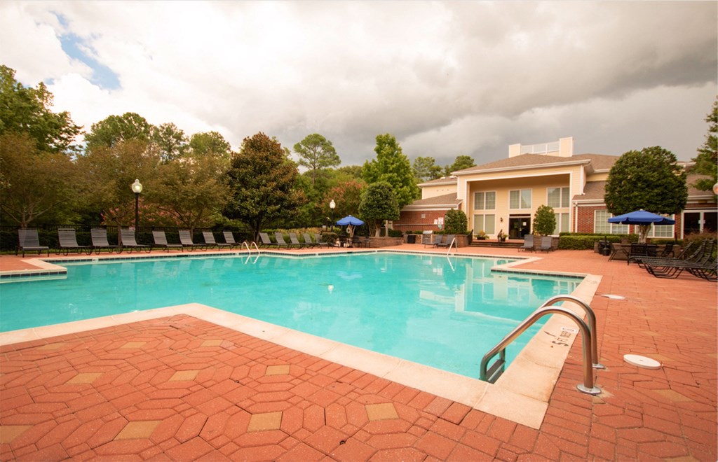 a swimming pool with a hotel in the background