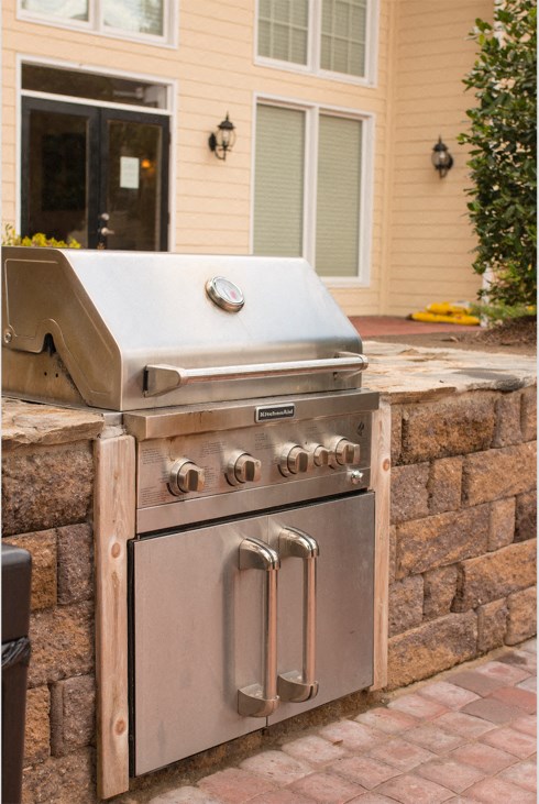 an outdoor stainless steel grill in front of a house