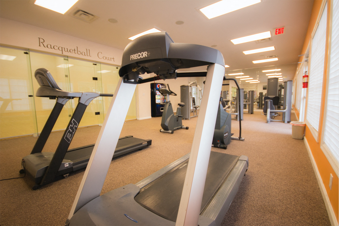 a gym with treadmills and other exercise equipment in a building