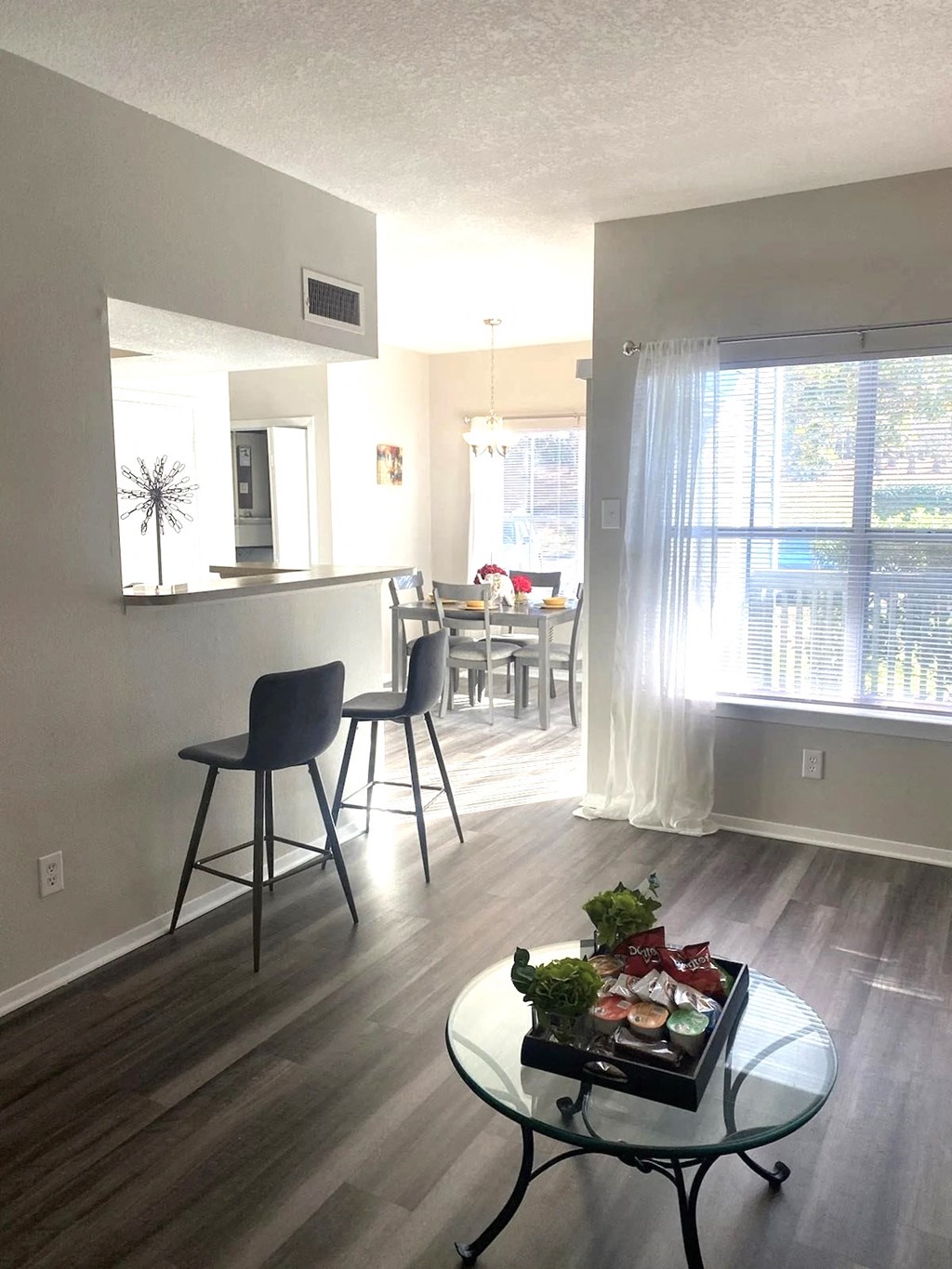 an open kitchen and living room with a table and chairs