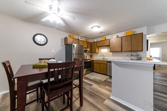 an open kitchen and dining area with a dining table and chairs