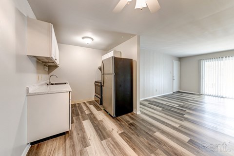 a kitchen with white cabinets and a stainless steel refrigerator