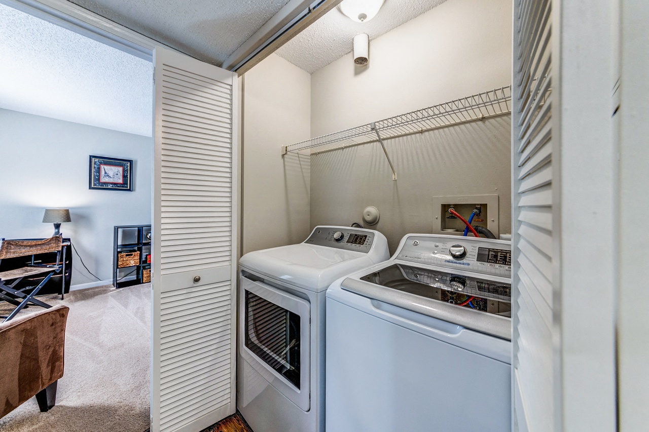 the laundry room is equipped with two washes and a dryer