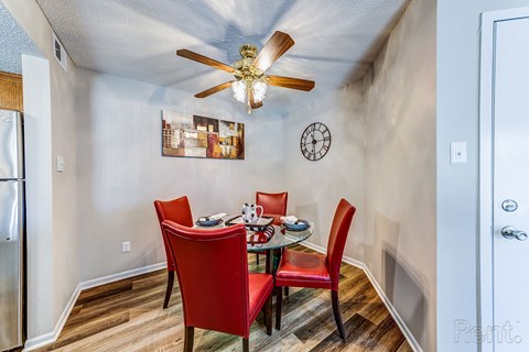 a dining room with a table and chairs and a ceiling fan