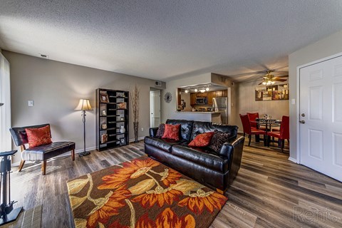 a living room with a leather couch and a rug