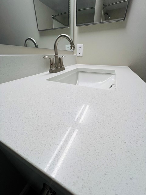 A white sink in a white bathroom.
