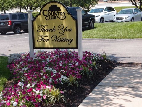 a sign for the country club thanks you for visiting