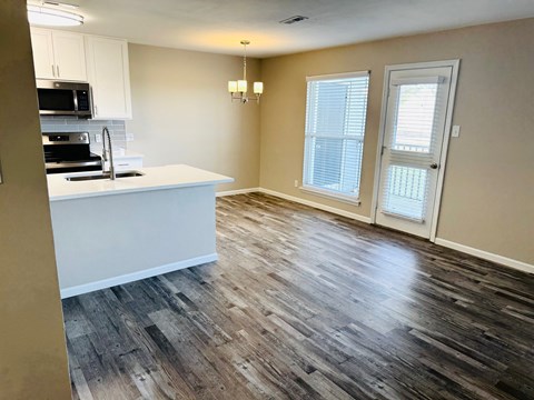 A kitchen with a white countertop and a black stove top oven.
