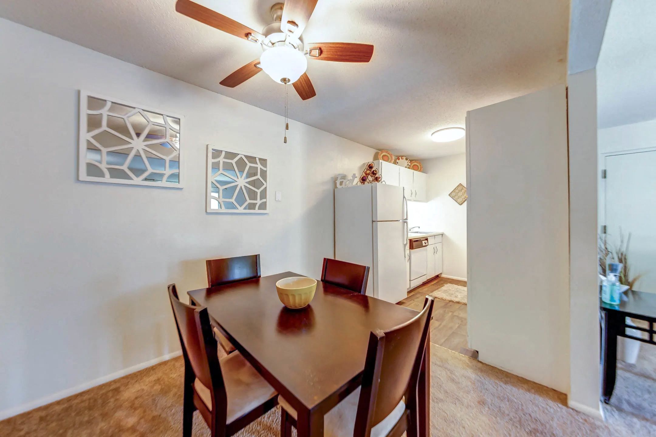 a dining room with a table and a ceiling fan