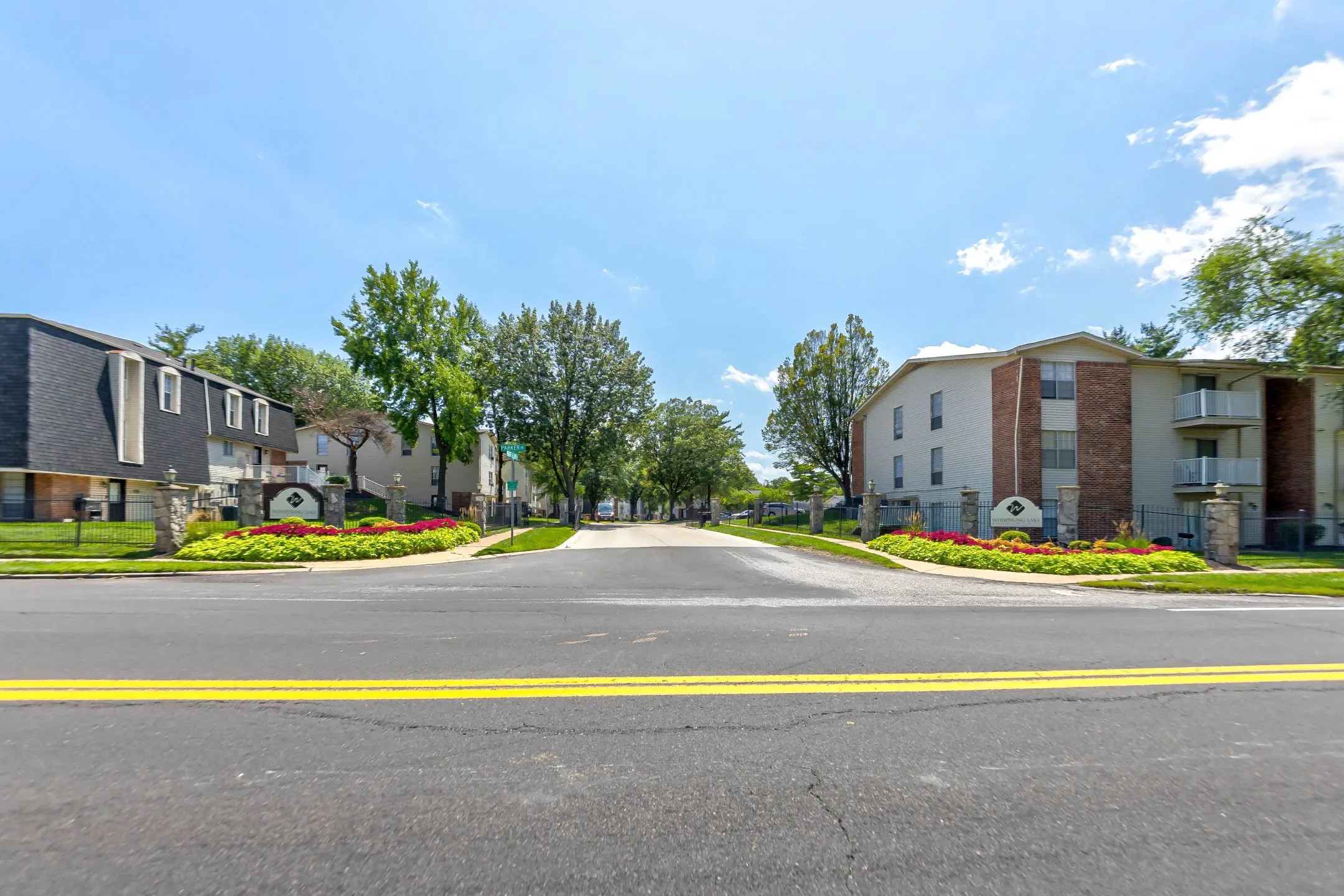 an empty street in front of an apartment building