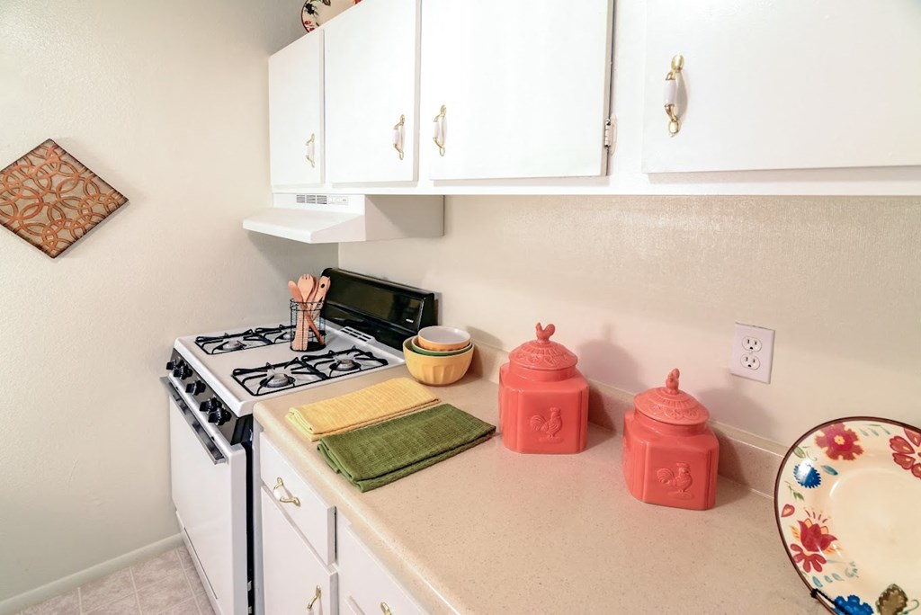 a kitchen with a stove top oven and a sink