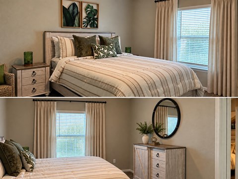 A bedroom with a large bed and a dresser with a mirror.