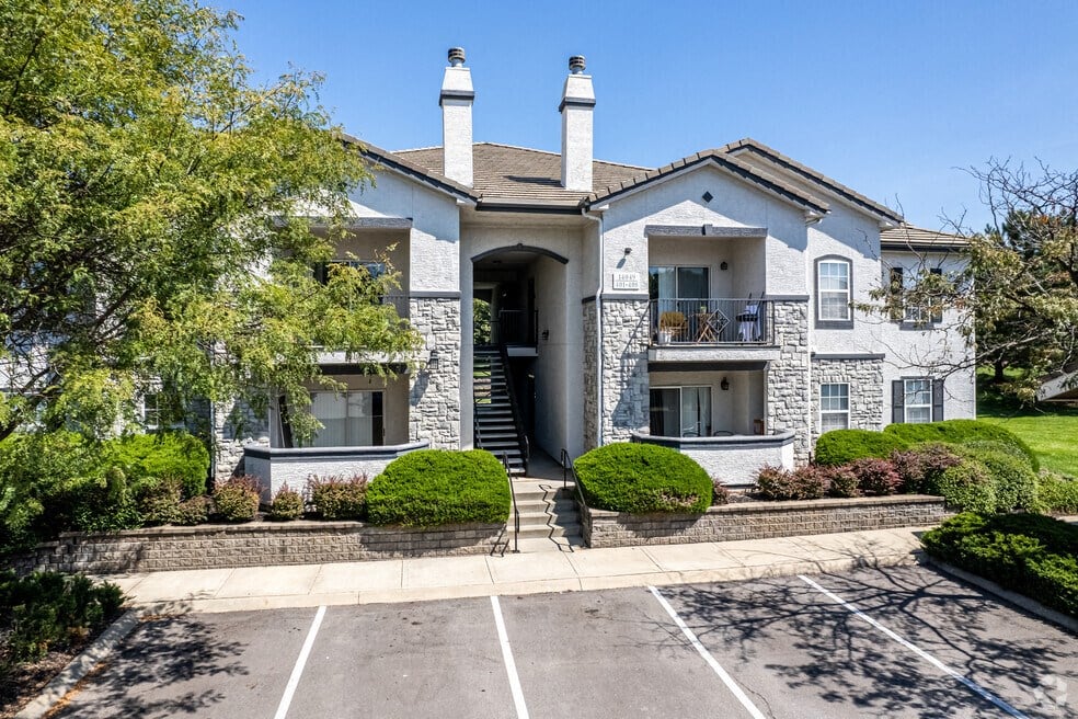 the front of a house with a driveway and stairs