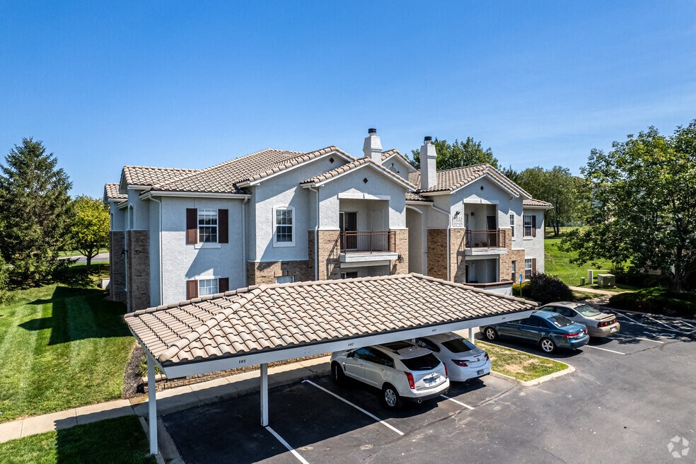 a house with cars parked in a parking lot