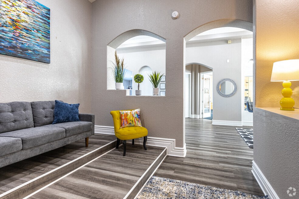 a living room with a couch and a yellow chair
