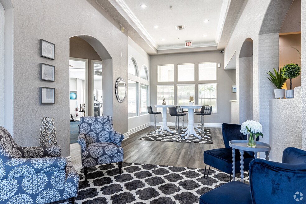 a living room with blue furniture and a table with chairs