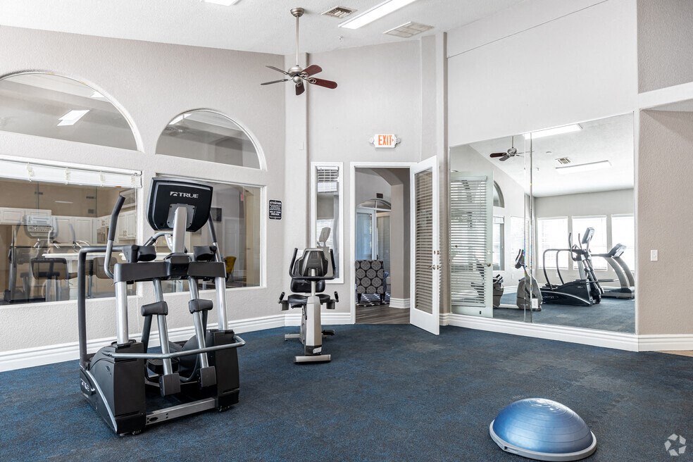 a gym with weights and cardio equipment at the district at highland village apartments