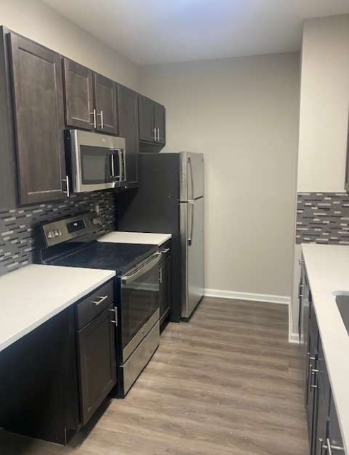 a kitchen with a stove and a refrigerator