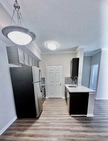 a kitchen with a refrigerator and a sink