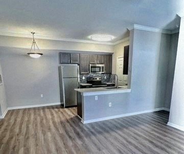 a kitchen with a stainless steel refrigerator and