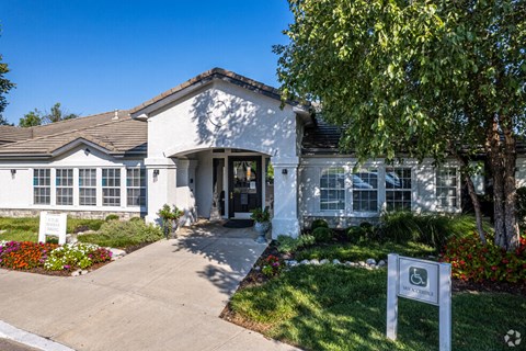a white house with a sign in front of it