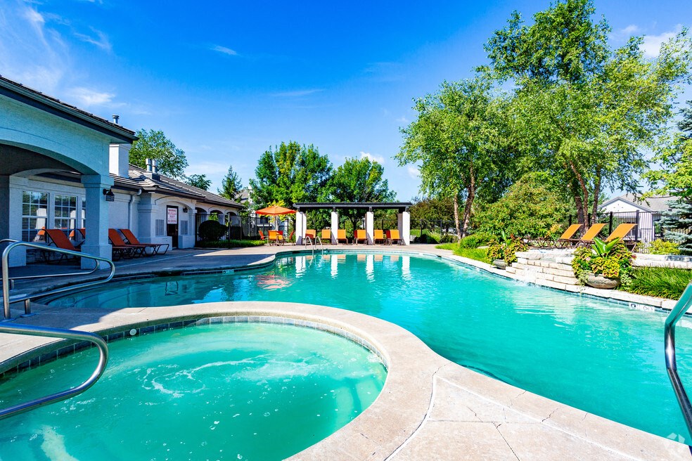 a swimming pool with a pool house and a resort style pool