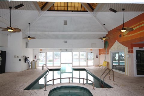 a swimming pool in the middle of a building with windows