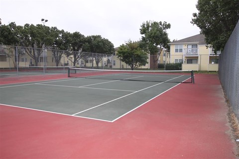 a tennis court with a net on a red court