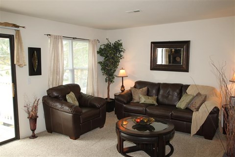 a living room with leather couches and a table
