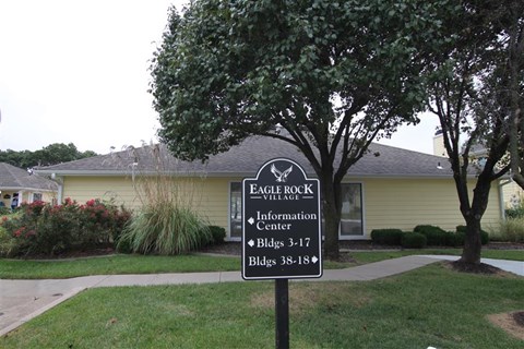 a sign in the front yard of a house