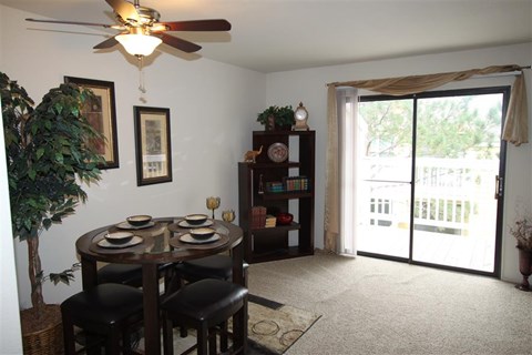 a dining room with a table and a ceiling fan