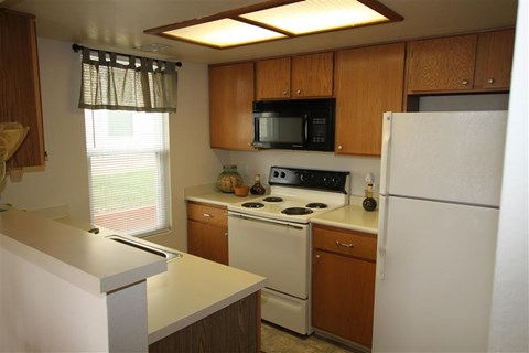 a kitchen with a stove and a refrigerator