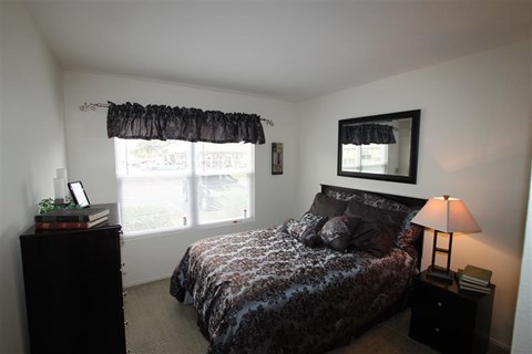 a bedroom with a bed and a window