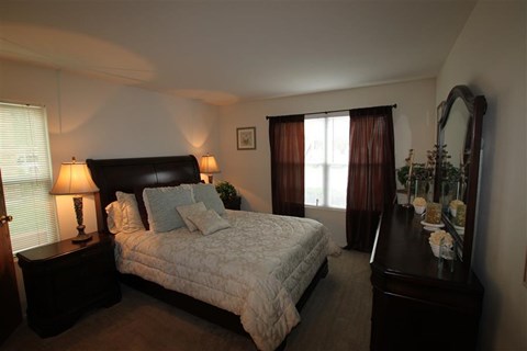a bedroom with a large bed and a dresser