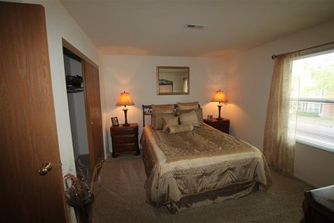 a bedroom with a bed and two lamps