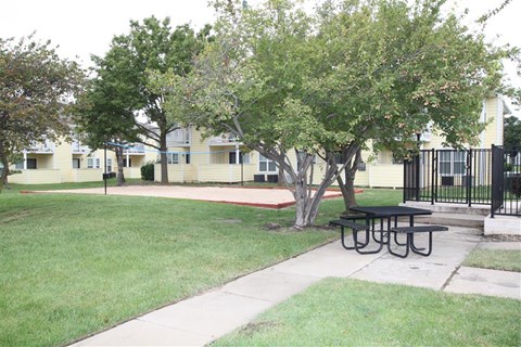 a picnic table on a sidewalk in a park