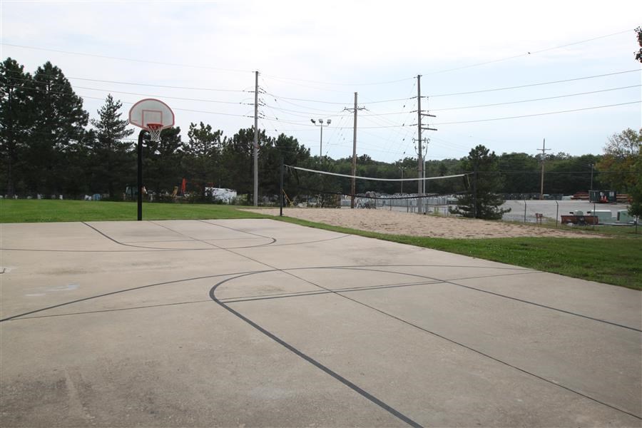 an empty basketball court with a basketball hoop on it