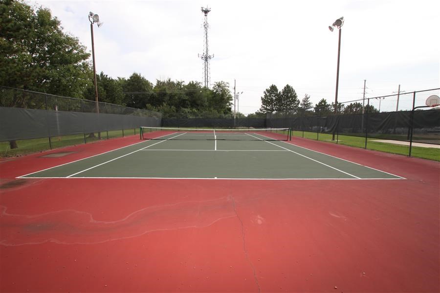 a tennis court with a green and red court