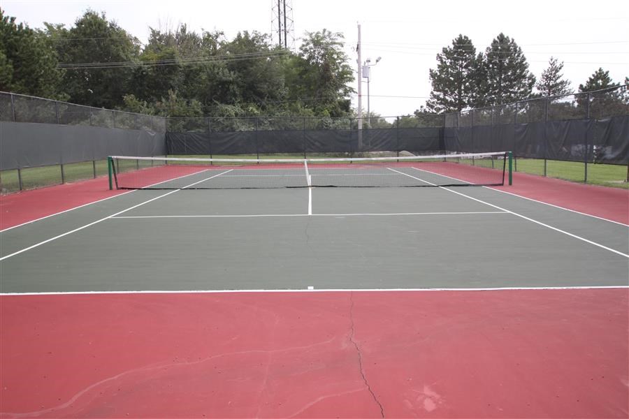 a tennis court with a green and red court