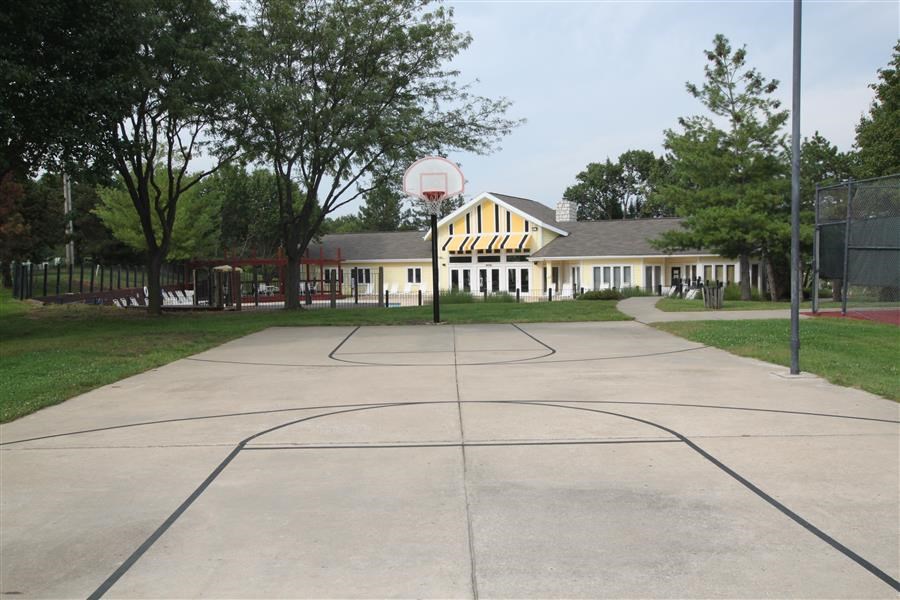 a basketball court in front of a school building