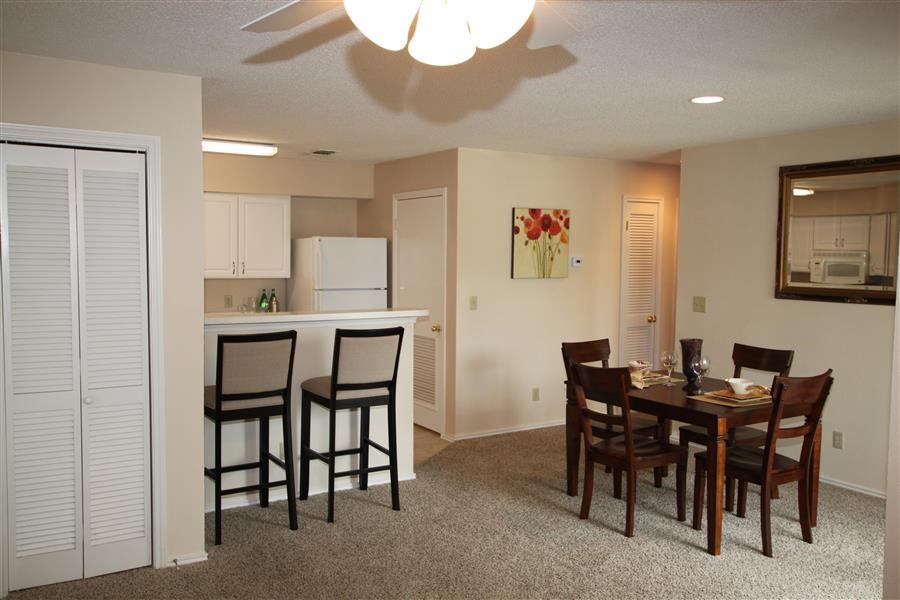 a dining room and kitchen with a table and chairs
