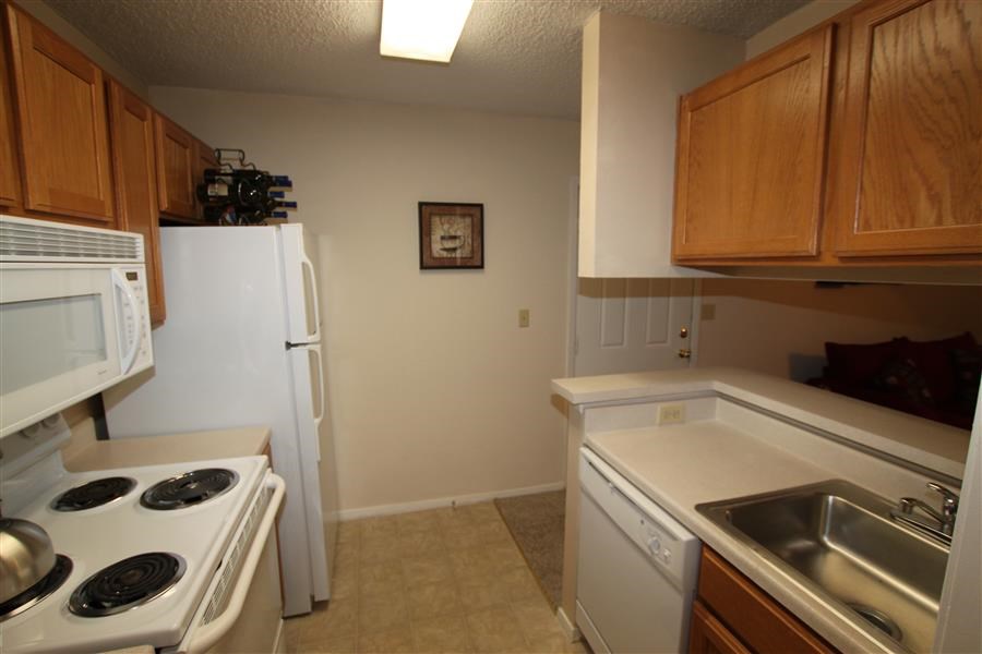 a kitchen with a stove refrigerator and sink